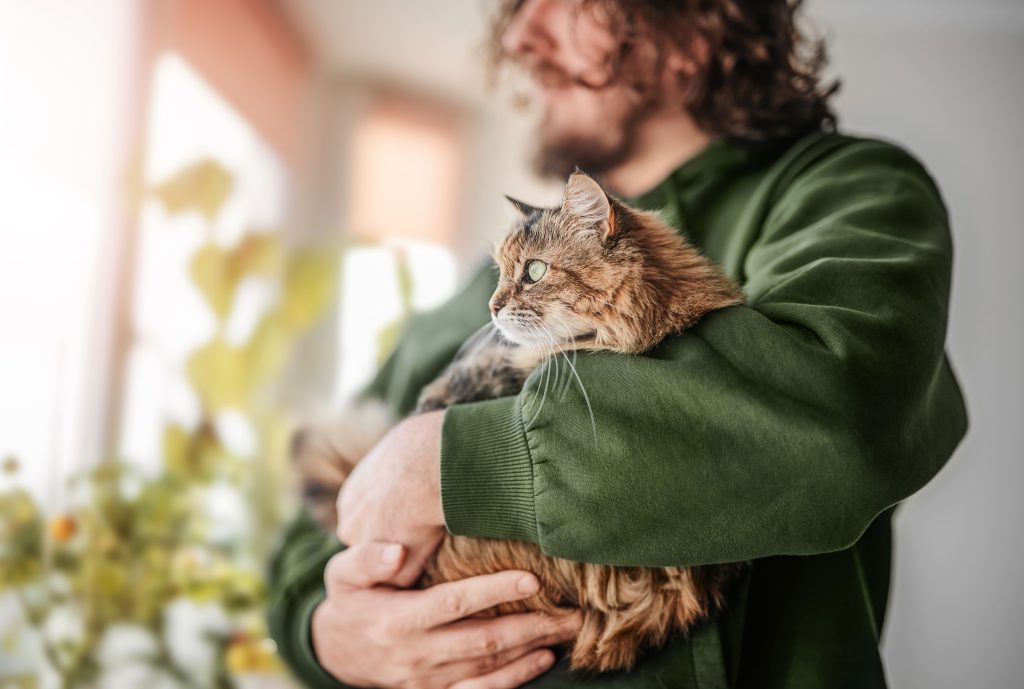 Mann mit Katze im Arm