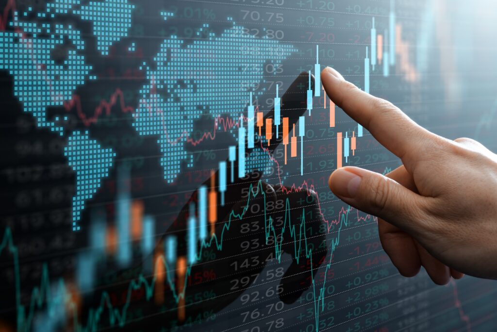 Candlestick chart and data of world financial market.  Analyst pointing the chart.
